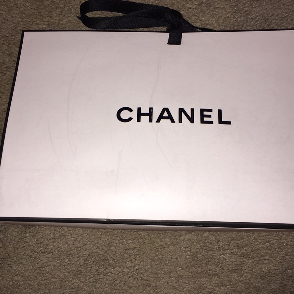 Authentic Chanel gift bag with black ribbon tie. Measures  9x6x3